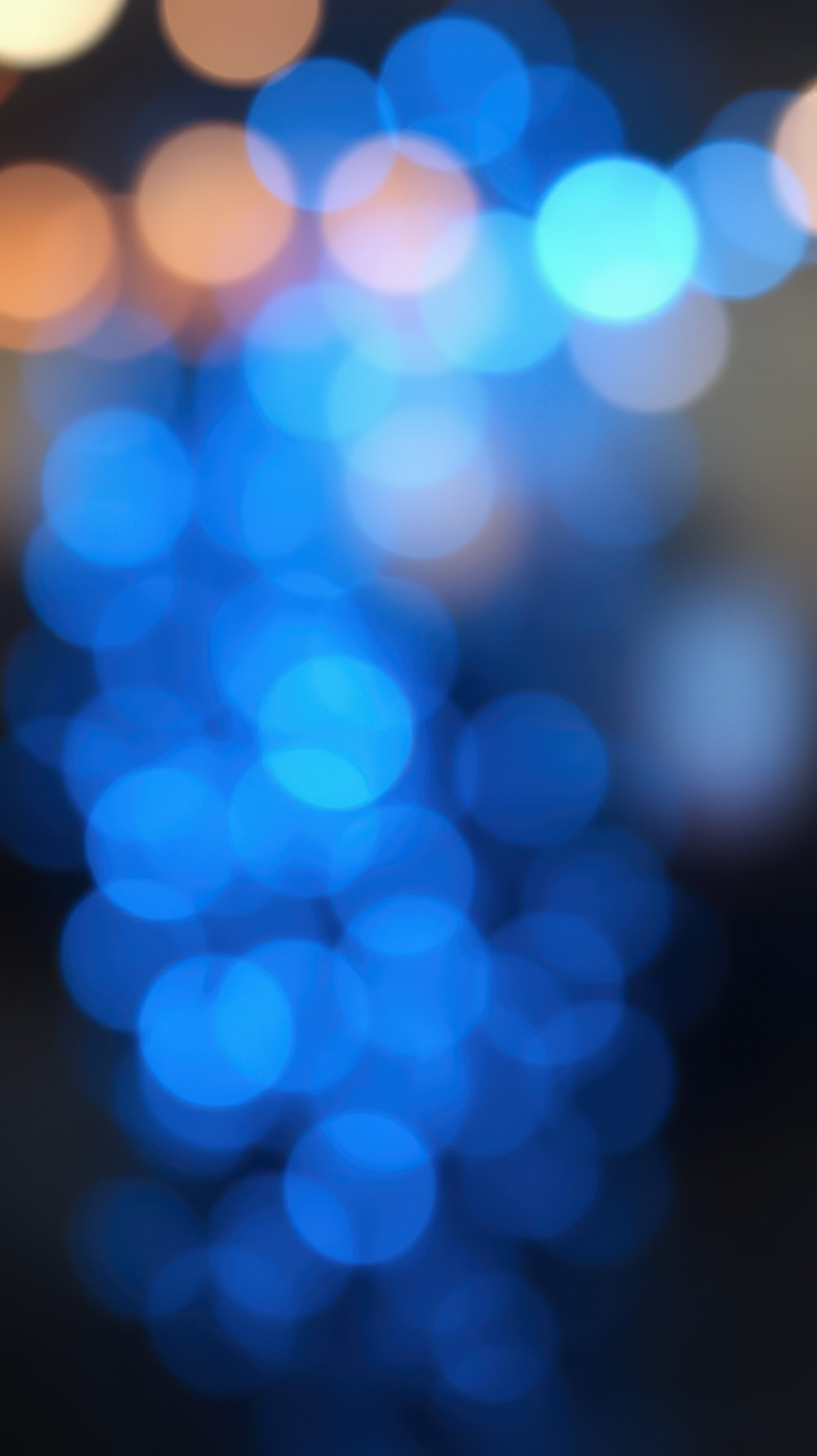 Colorful blue bokeh lights create a festive atmosphere during evening celebrations